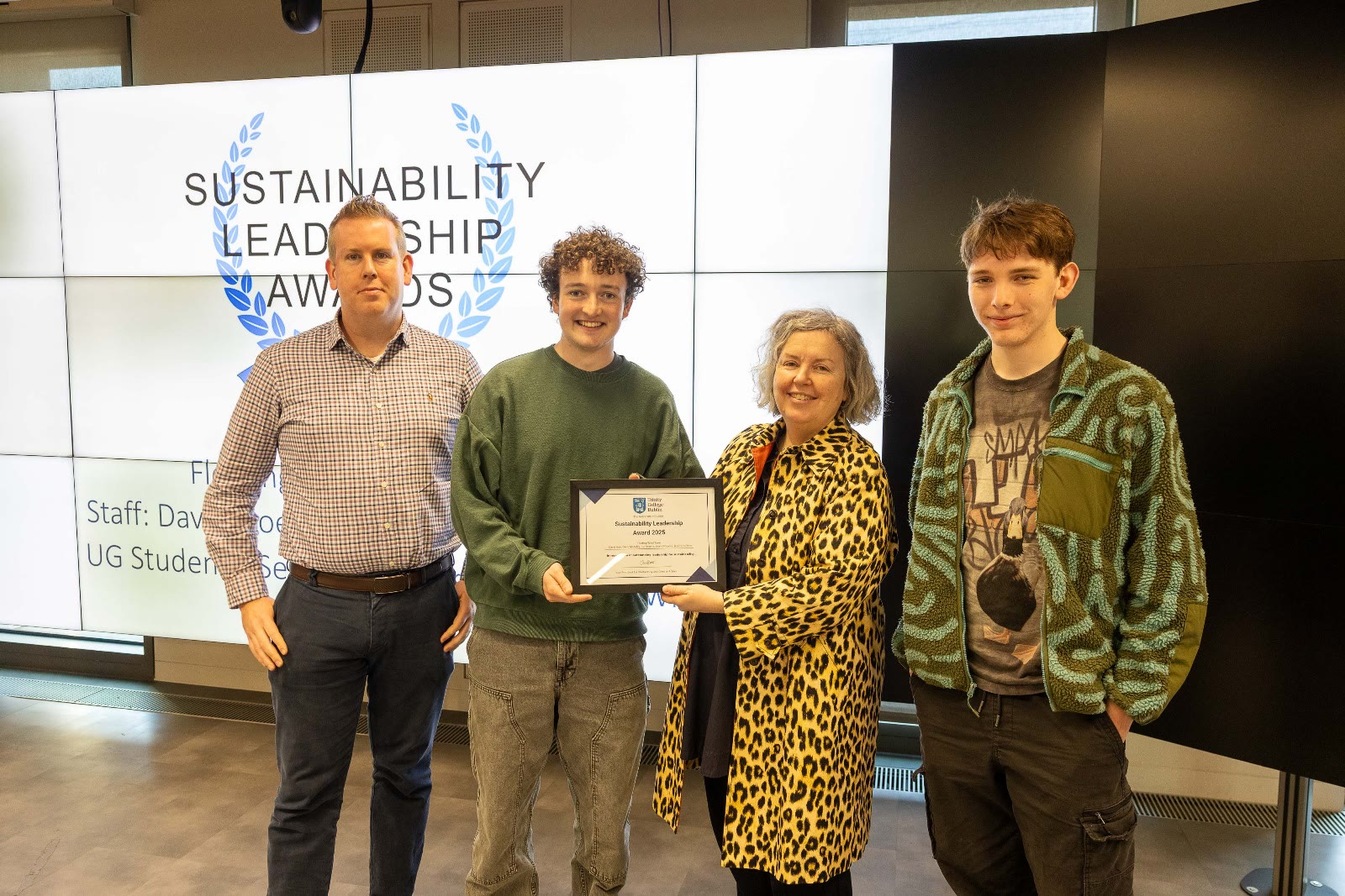 Four people with the Sustainability Leadership Awards certificate