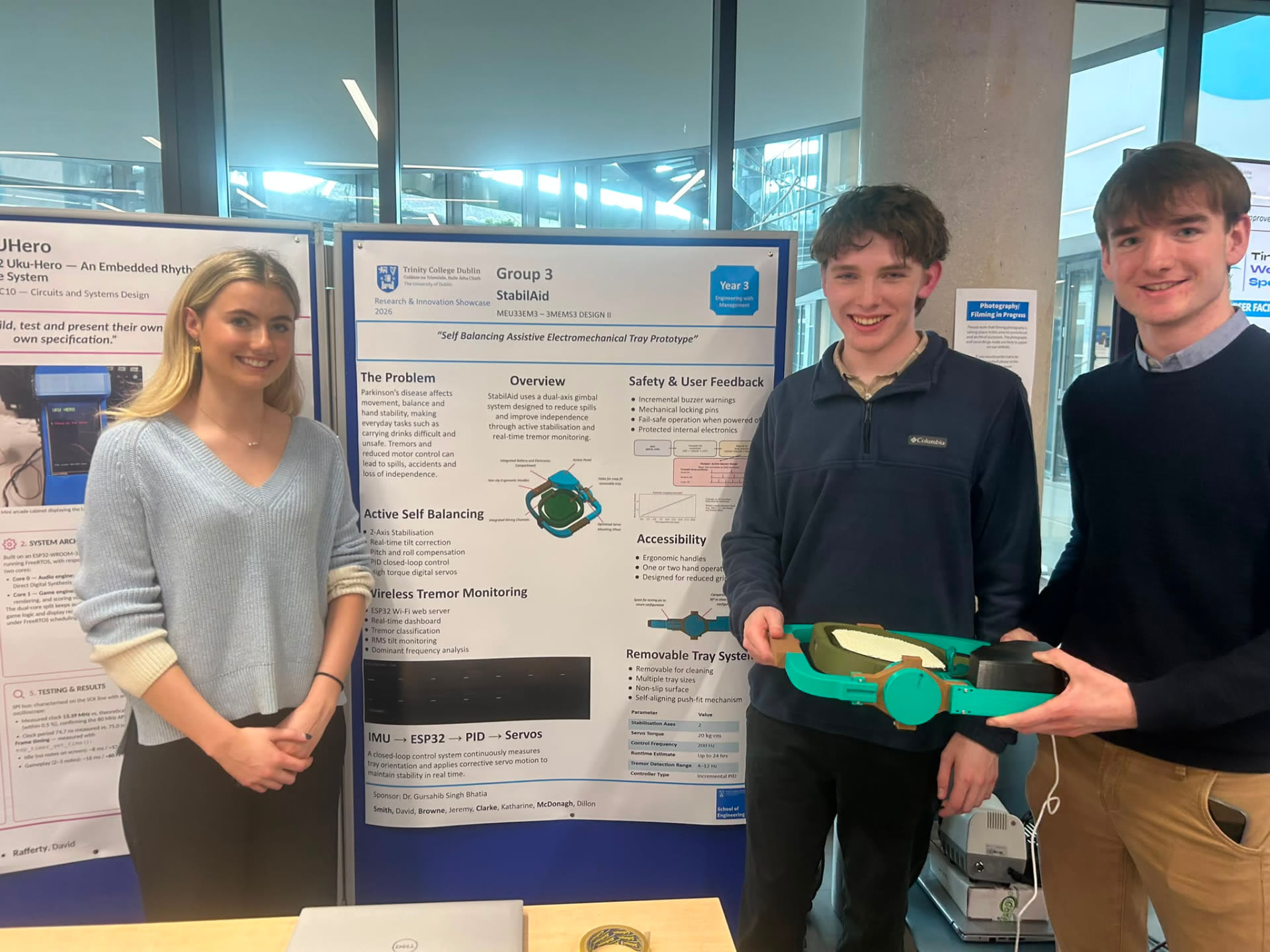The StabilAid team presenting their poster and tray prototype