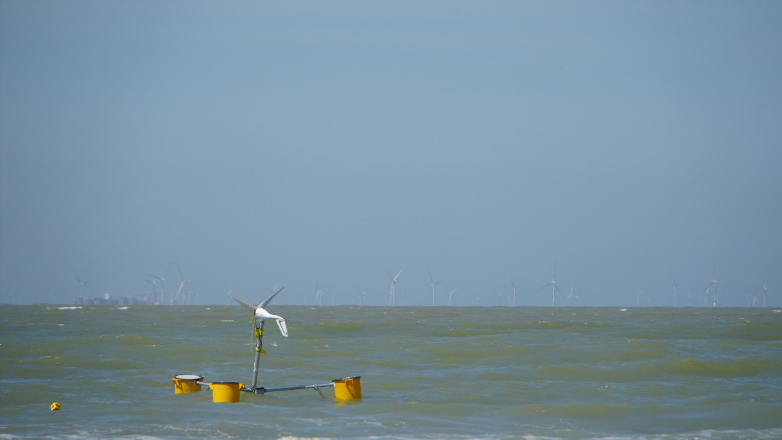 The Trinity Floating Wind platform under test at sea with an offshore wind farm on the horizon